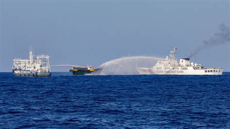 Philippines and China again clash in disputed waters .